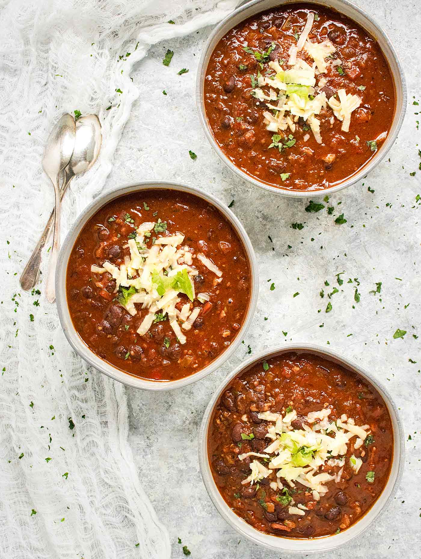 Three bowls of BBQ Black Bean Soup, lined up and ready to serve