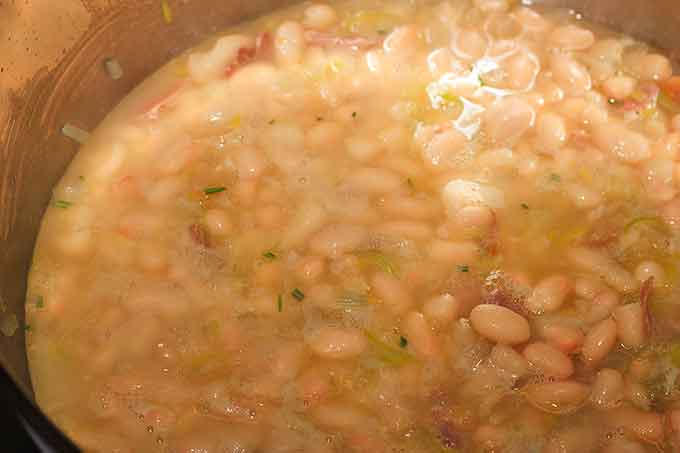 Tuscan White Bean Soup cooking up in the pot.