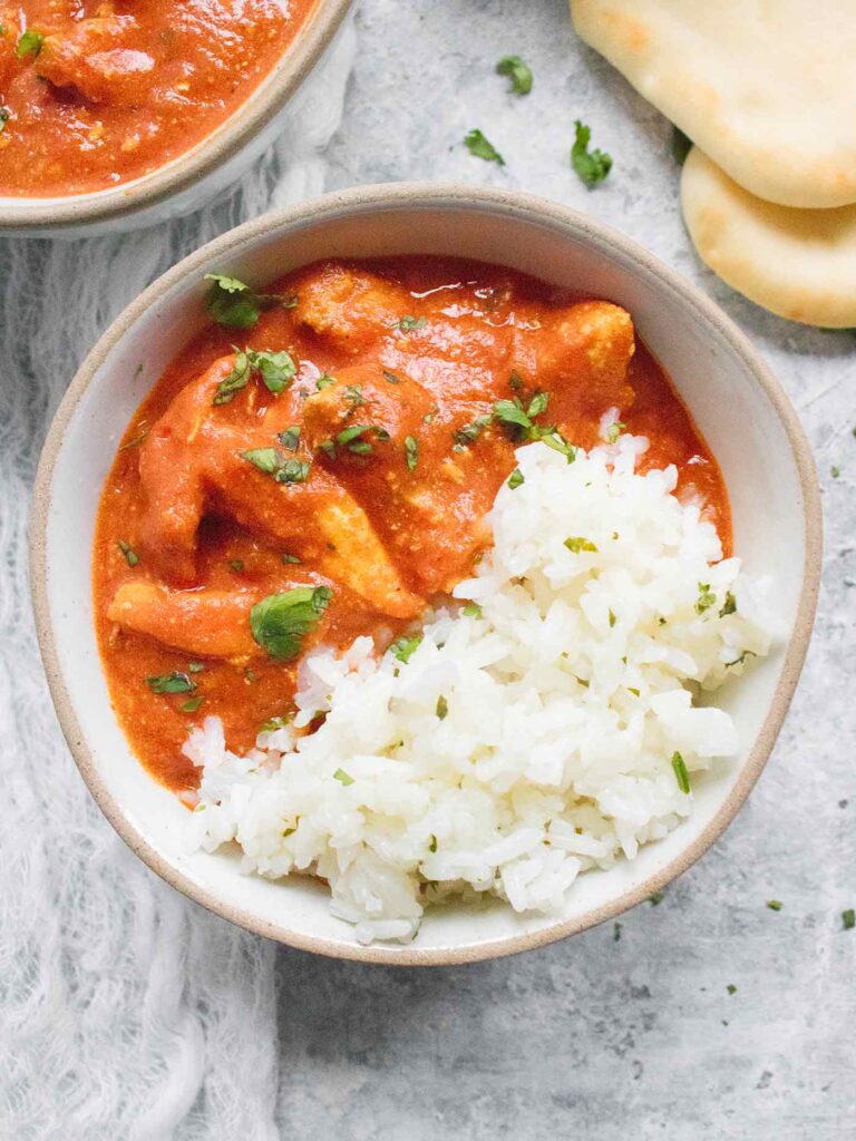 Chicken Tikka Masala served over rice in a bowl