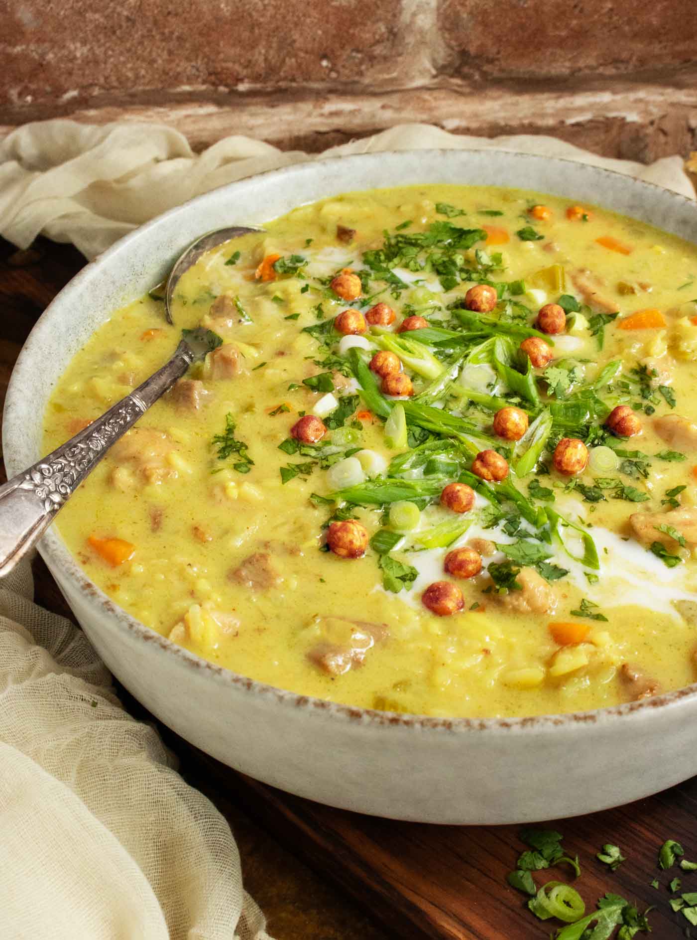 Side-angled view of a bowl of Mulligatawny Soup.