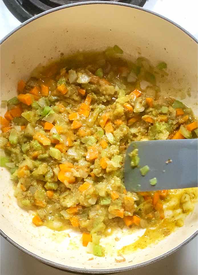 Finishing the flavorful vegetable base.