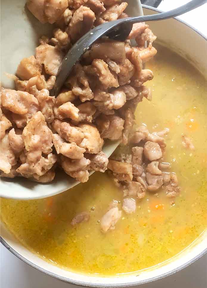 Returning the chicken to the pot