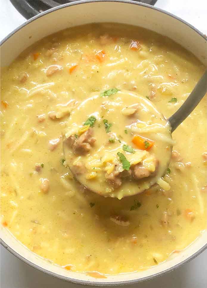 Close-up of a ladleful of the finished soup.