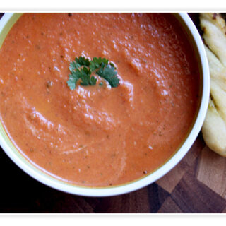 Classic tomato soup in a white bowl