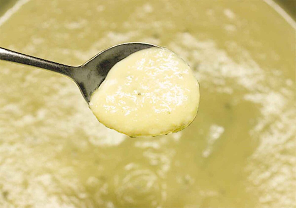 Close up of a spoonful of garlic soup.