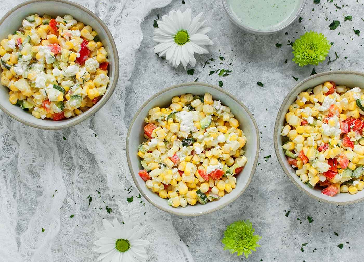 Three bowls of Sweet Corn Salad with Creamy Dill Dressing on the side