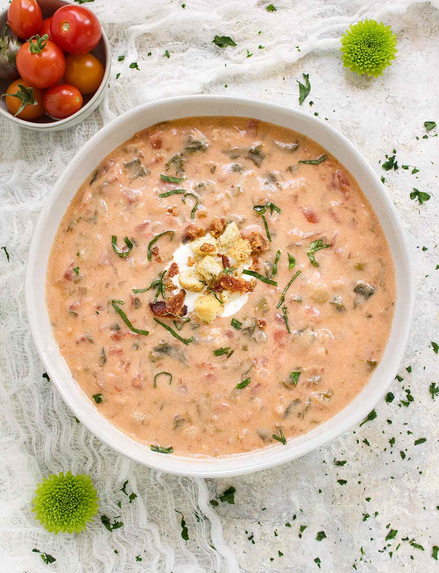 One big bowl of BLT Soup garnished with croutons and basil slivers