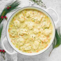 Chicken and Dumplings in a large, white Dutch oven