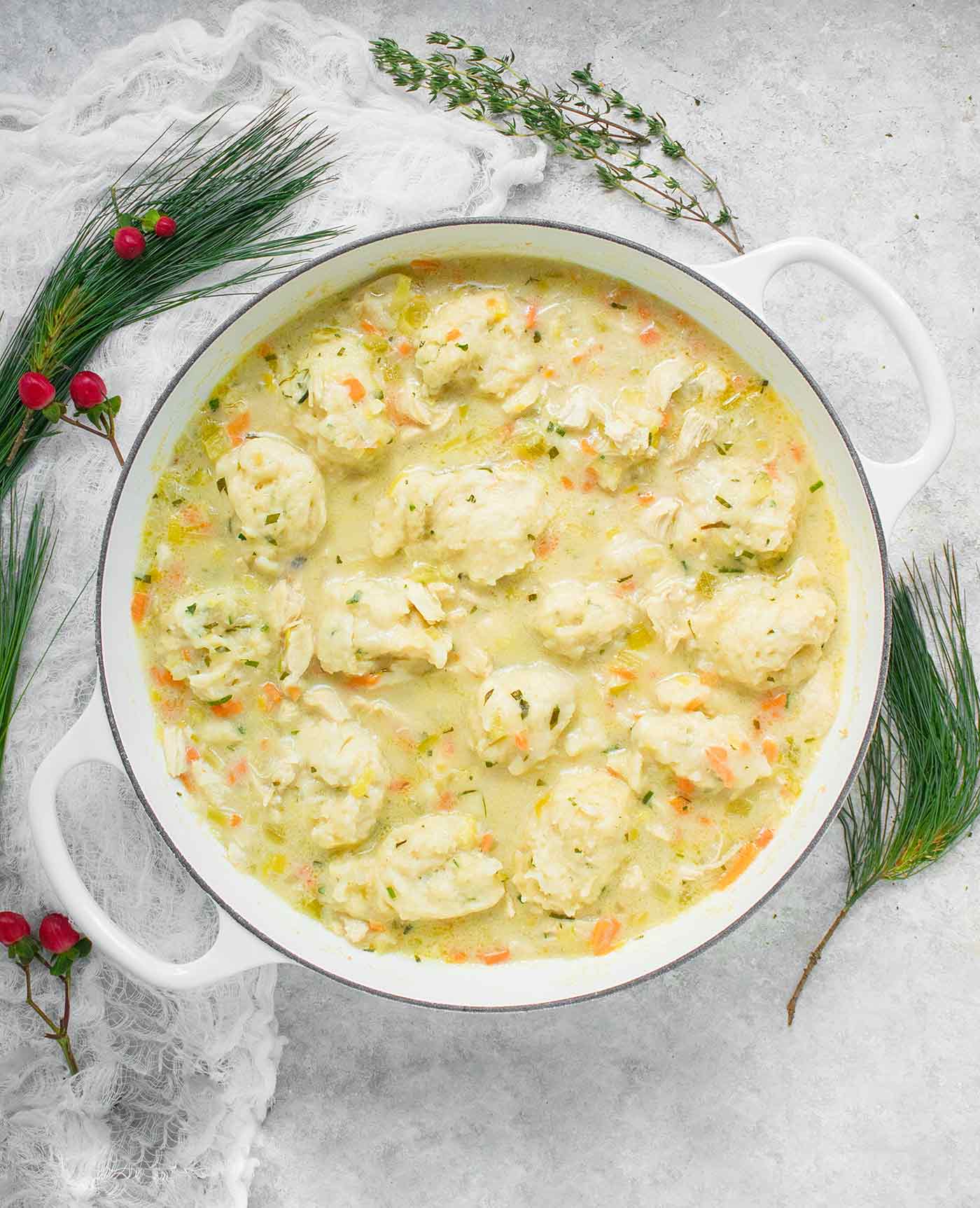 Chicken and Dumplings in a large, white Dutch oven