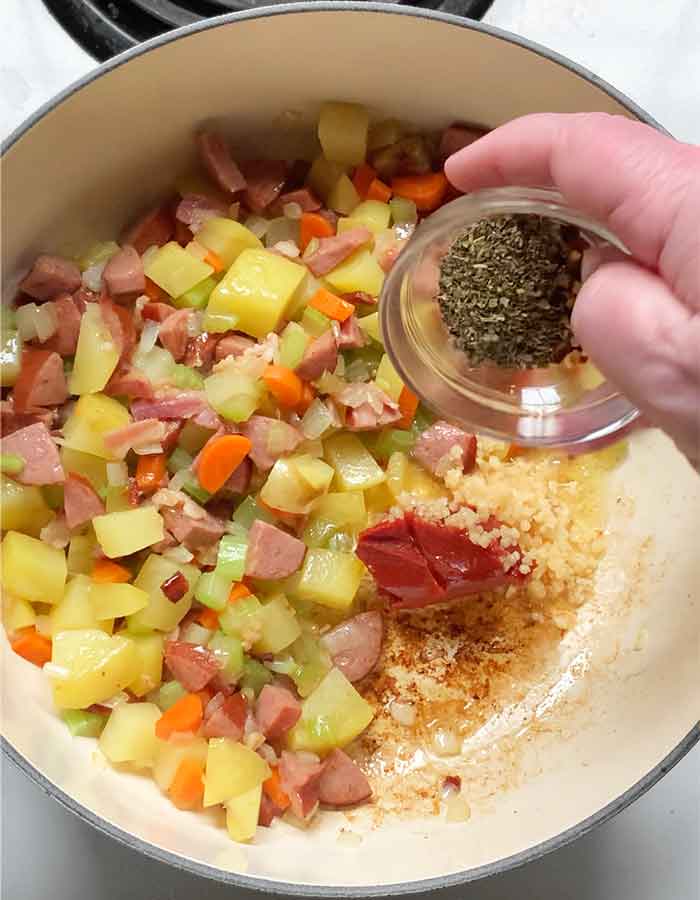 Spices, garlic and tomato paste blooming in the pot.