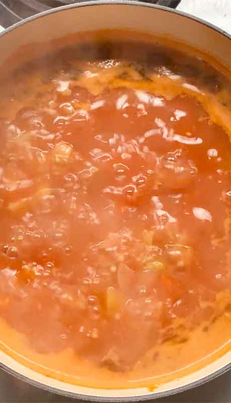 Bringing the soup up to a boil.