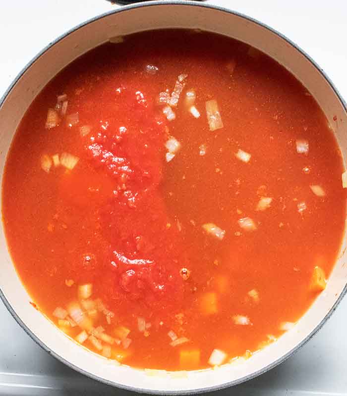 Add the soup liquids and simmer.