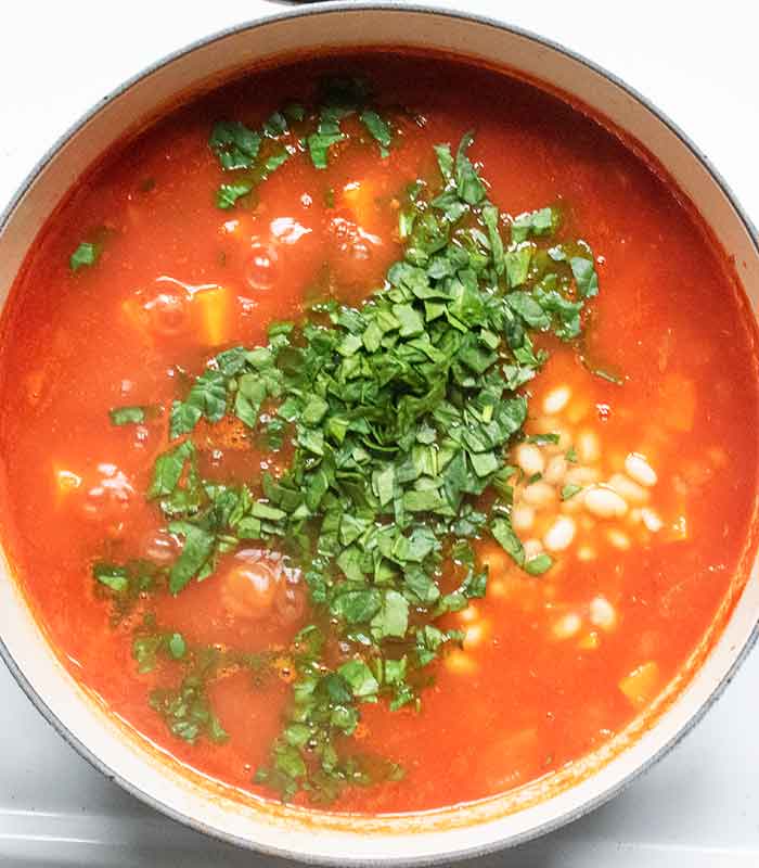 Stir in the beans and greens.