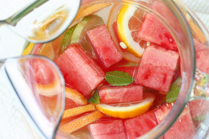 Close-up view of the top of a pitcher filled with fruit-infused water.