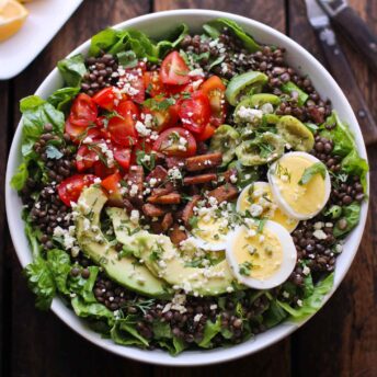 Overhead photo of Vegetarian Cobb Salad Lentil Bowl in a white bowl.