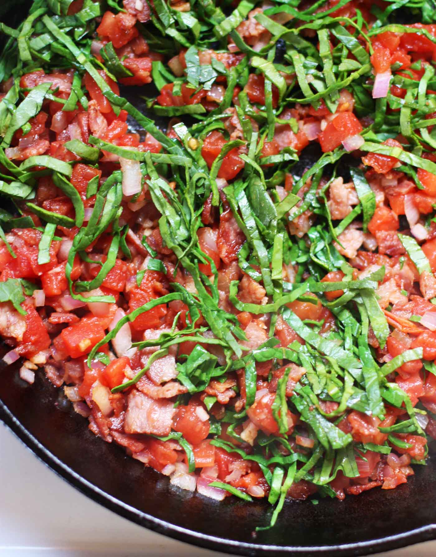 BLT ingredients cooking in the pan.