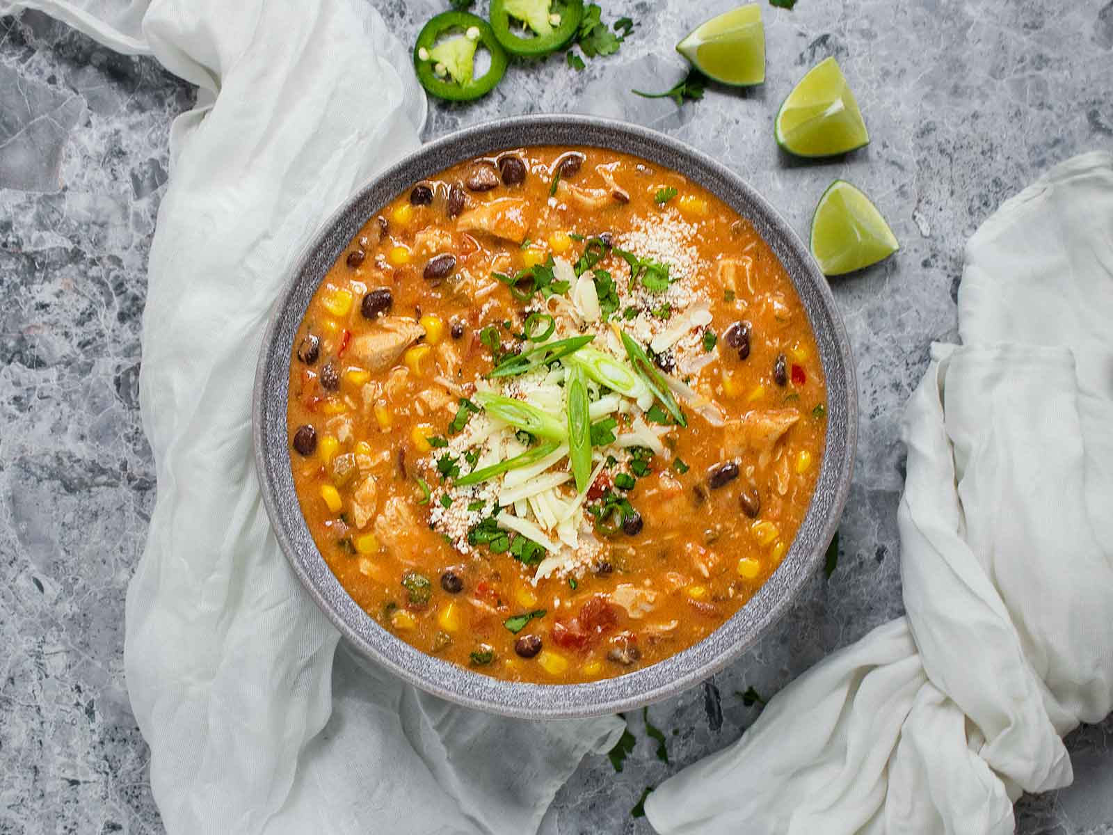Overhead photo of Chicken Enchilada Soup in a gray bowl.