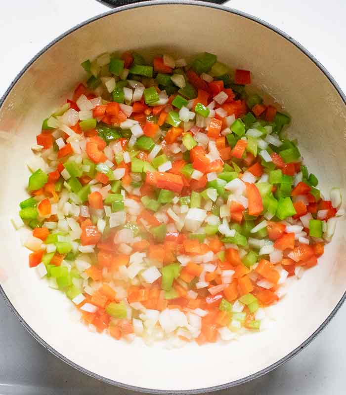 Sauteeing the aromatic vegetables in the pot.