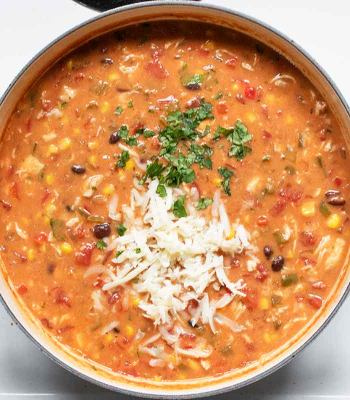 Finally, adding cheese and cilantro to finish the soup.