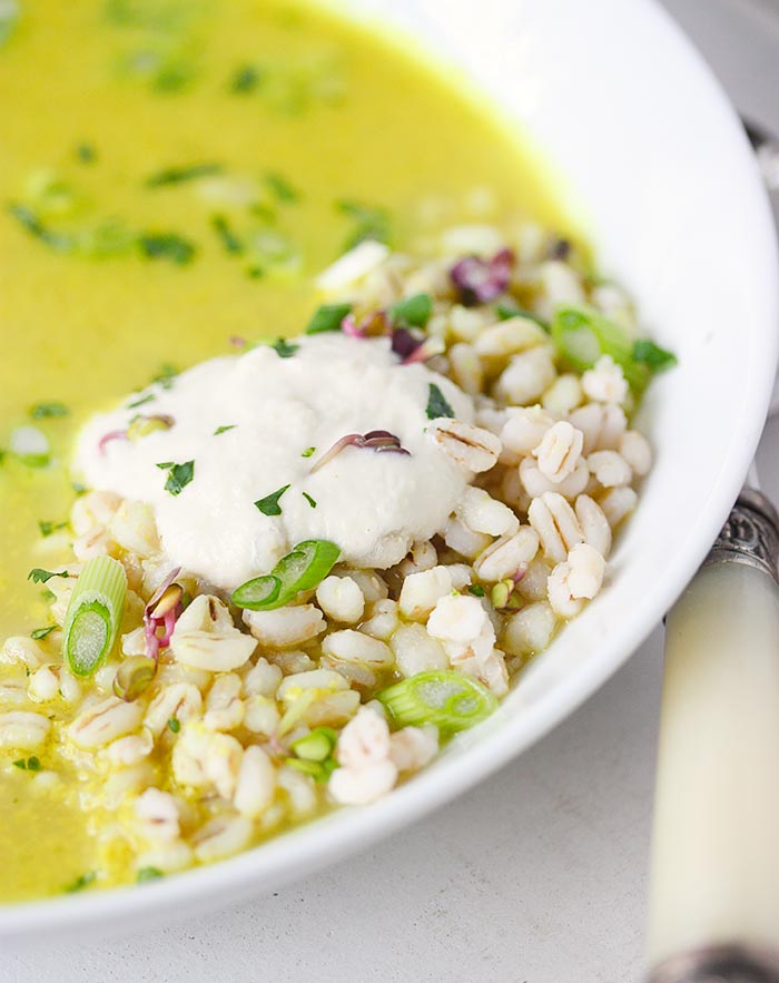 Close-up of barley and cashew cream in the soup bowl.