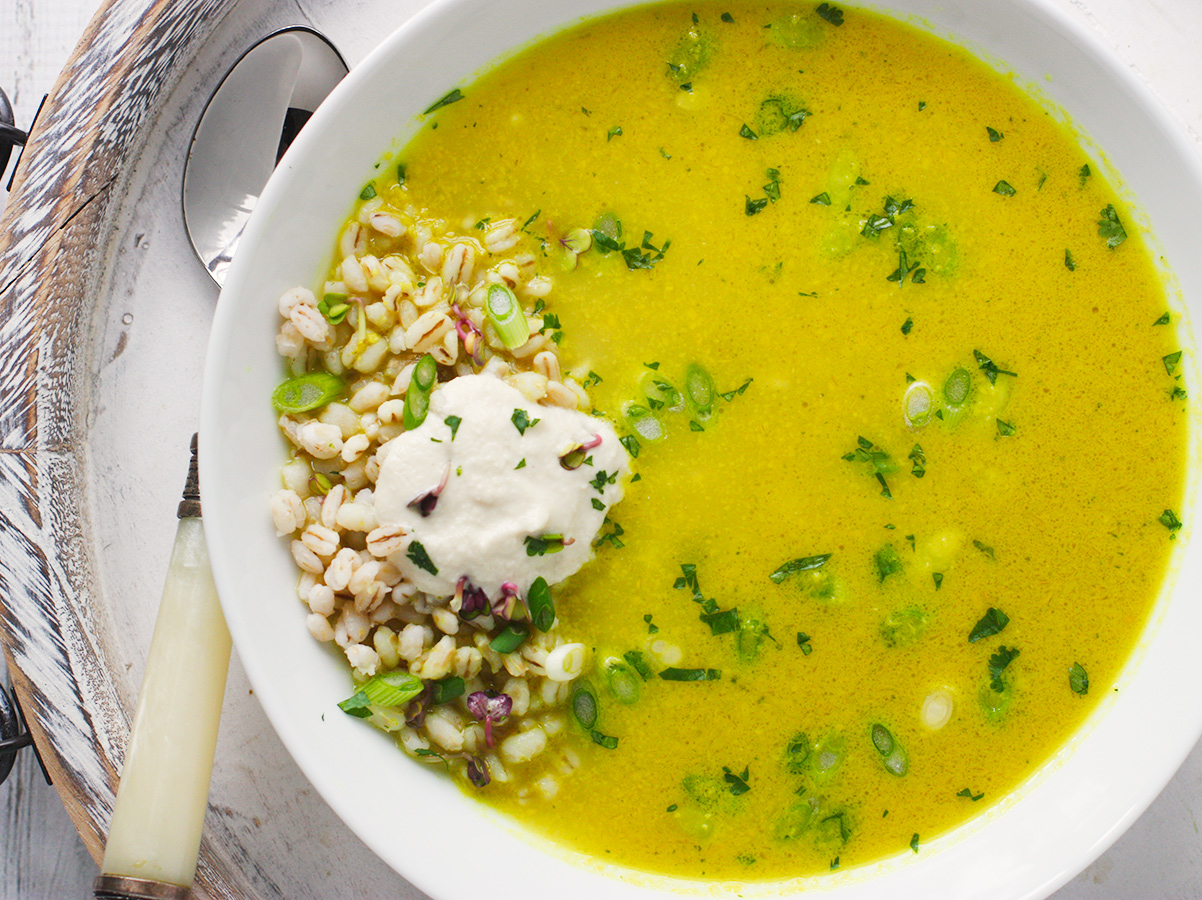 An overhead view of Lemongrass Curry Soup in a white bowl.