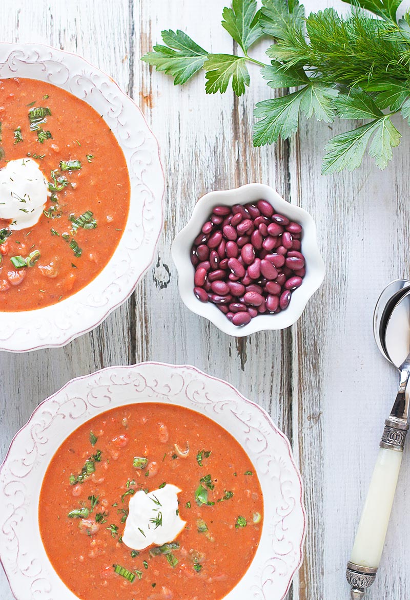 Overhead view of bowls of red bean soup, plus a small bowl of the dried red beans.