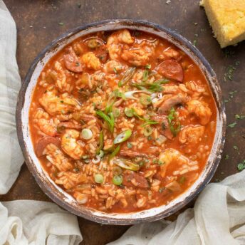 Overhead view of Jambalaya Soup in a rustic ceramic bowl.