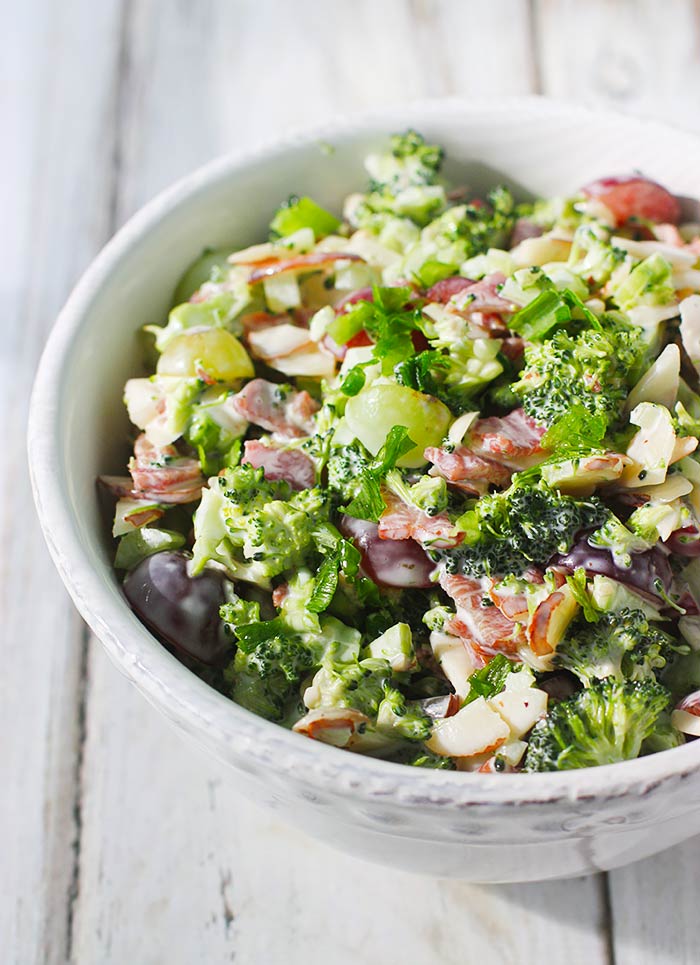 Lightened up broccoli grape salad in a white bowl