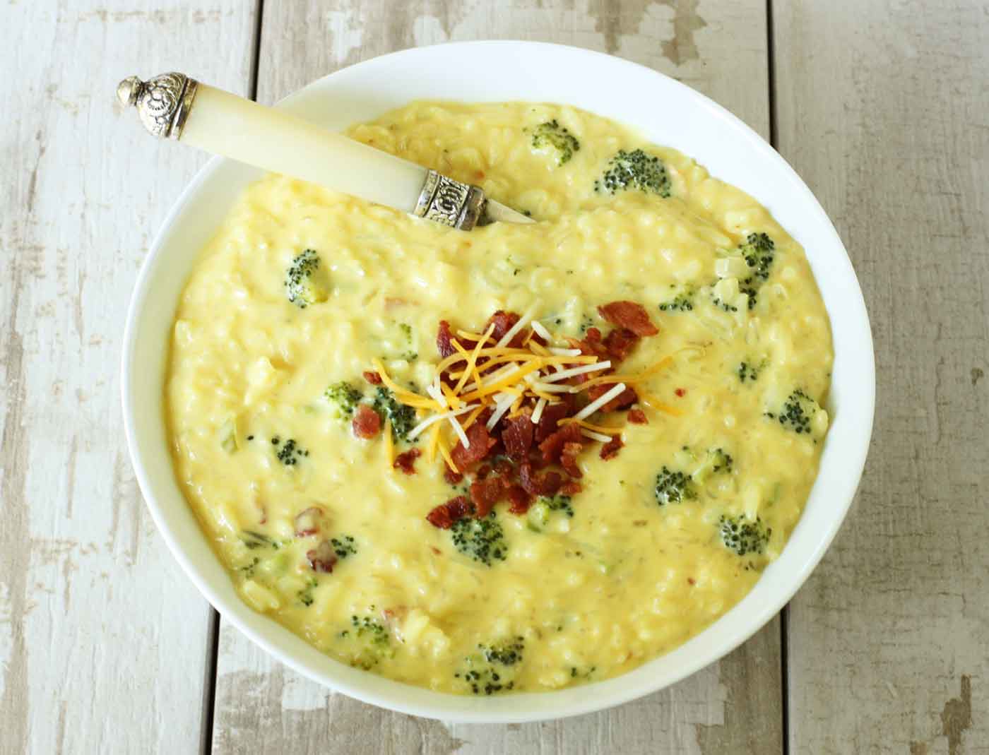 Cheesy Broccoli Rice Soup in a bowl with a spoon.