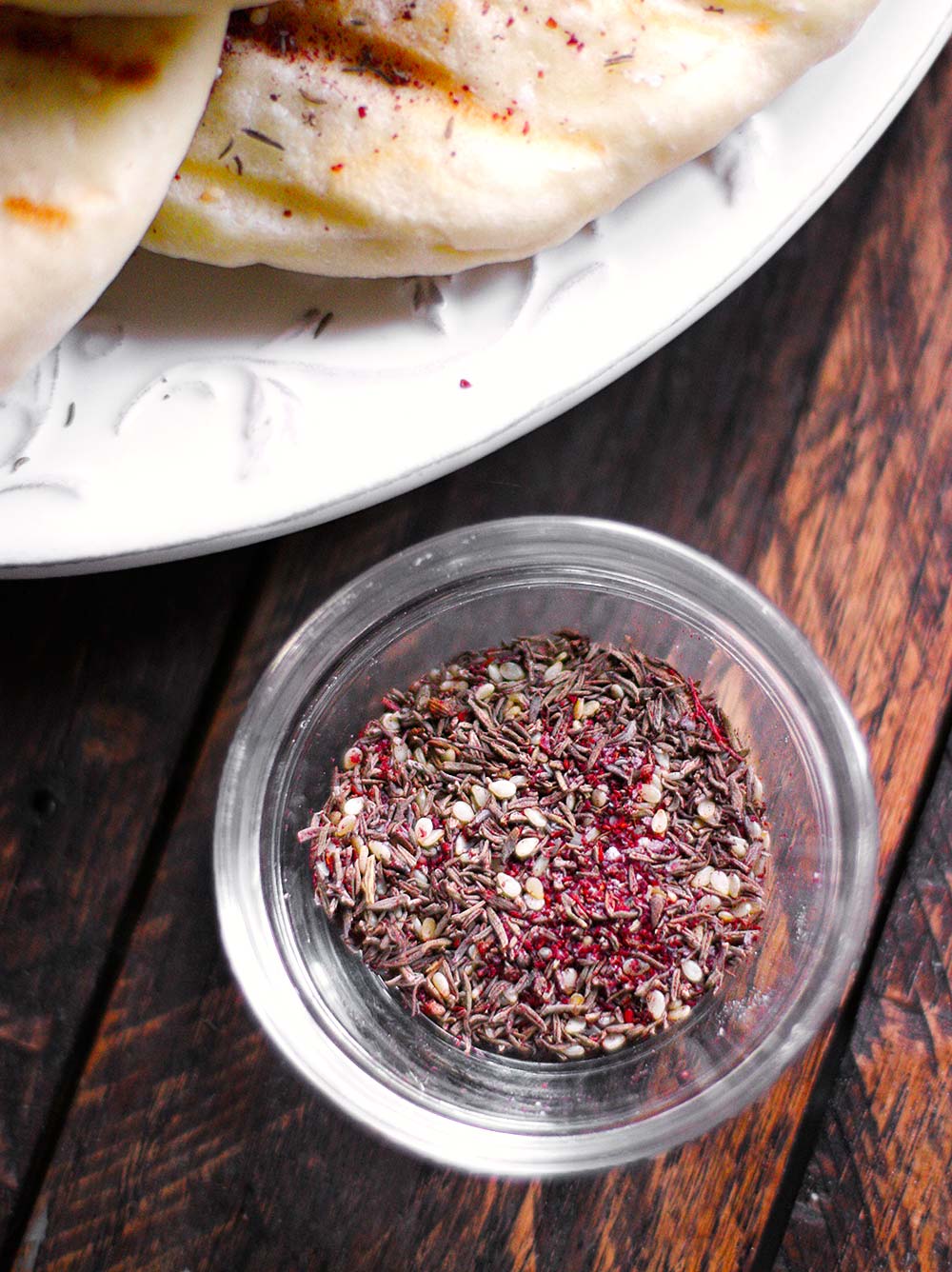 Close up of za'atar spice in a glass pinch bowl.