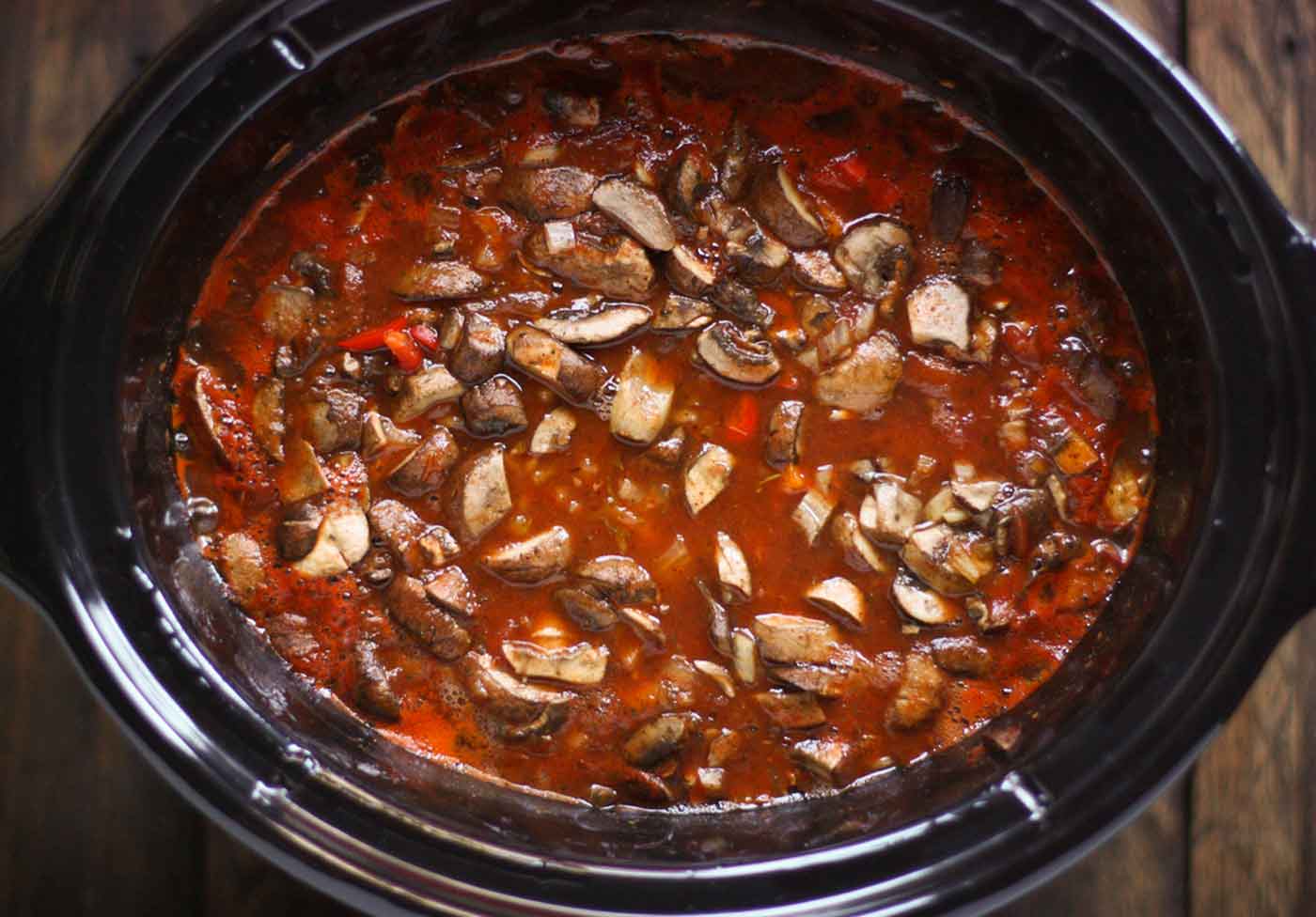 Overhead view of Chicken Chili Soup in the inner pot of a slow cooker.