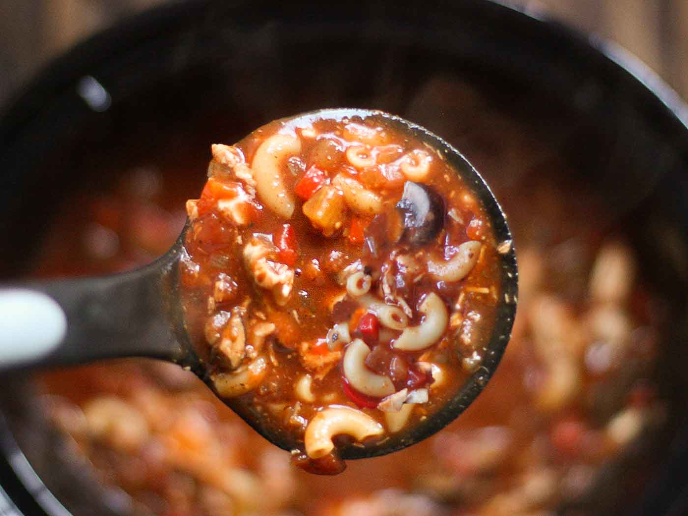 Close-up view of a ladle of Slow Cooker Chicken Chili Soup.