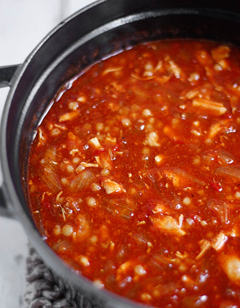 Side-angled, partial view of a pot of Moroccan Chicken Soup.