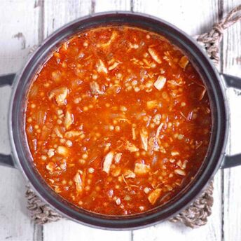 A pot of Moroccan Chicken Soup on a white board.