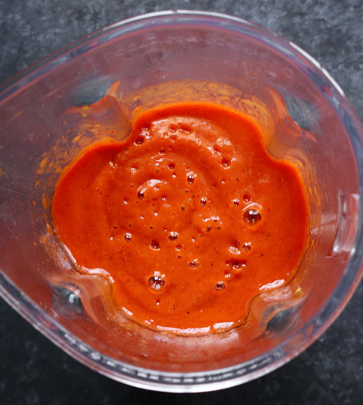 The vibrant red vegetables blended in the blender