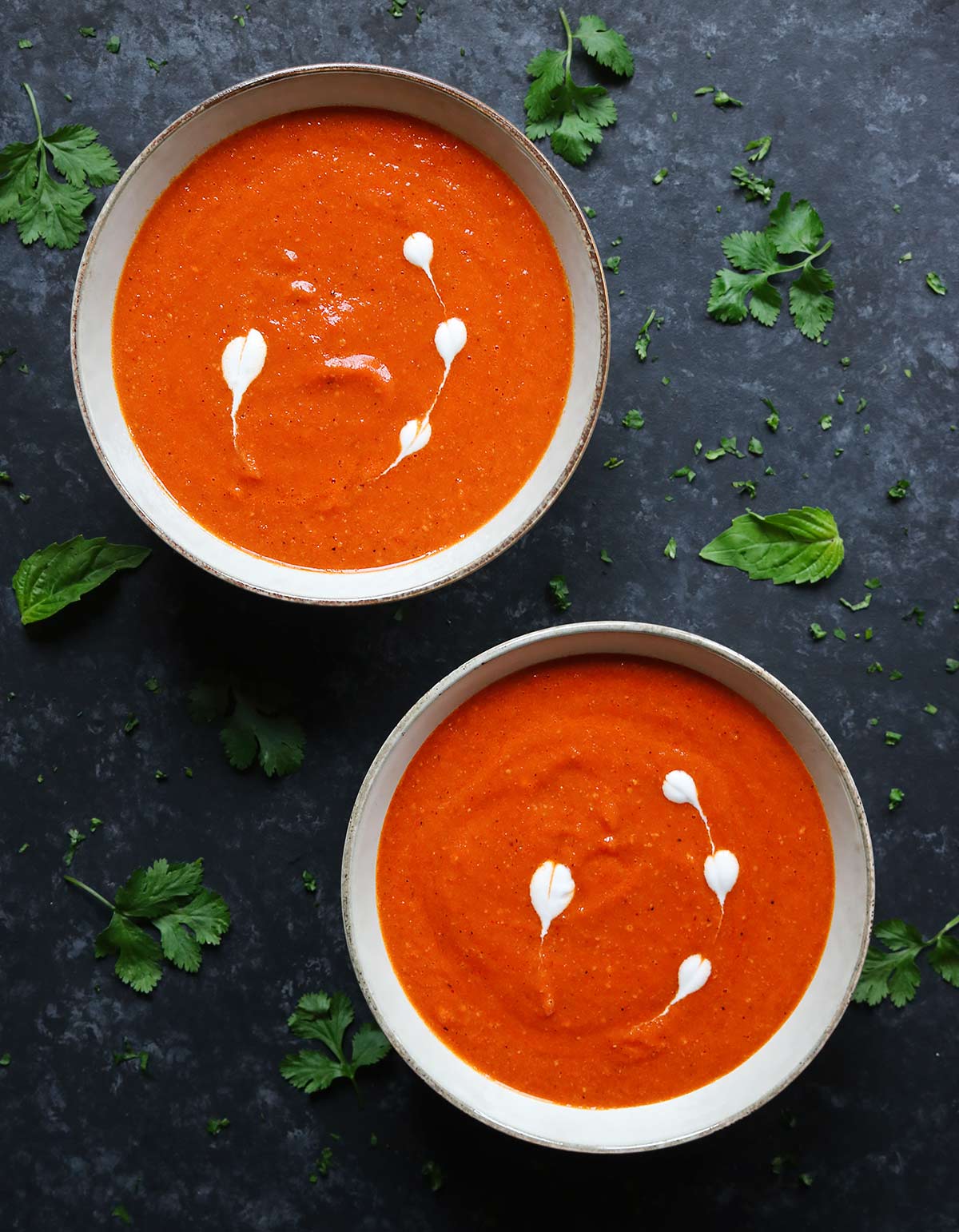 Overhead shot of two bowls of Sheet Pan Roasted Red Pepper Tomato Soup