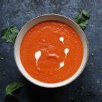 A bowl of Sheet Pan Roasted Red Pepper Tomato Soup.