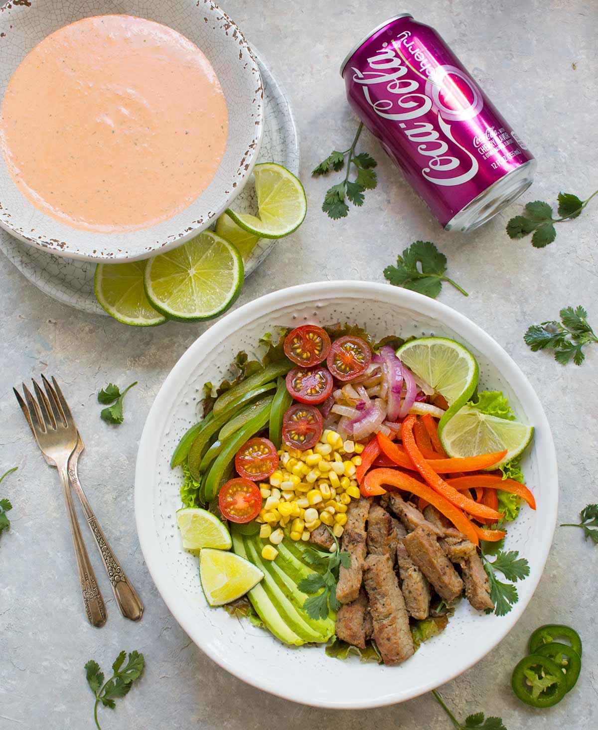 Beef Fajita Salad with Creamy Salsa Dressing, served in a bowl, with a can of Cherry Coke