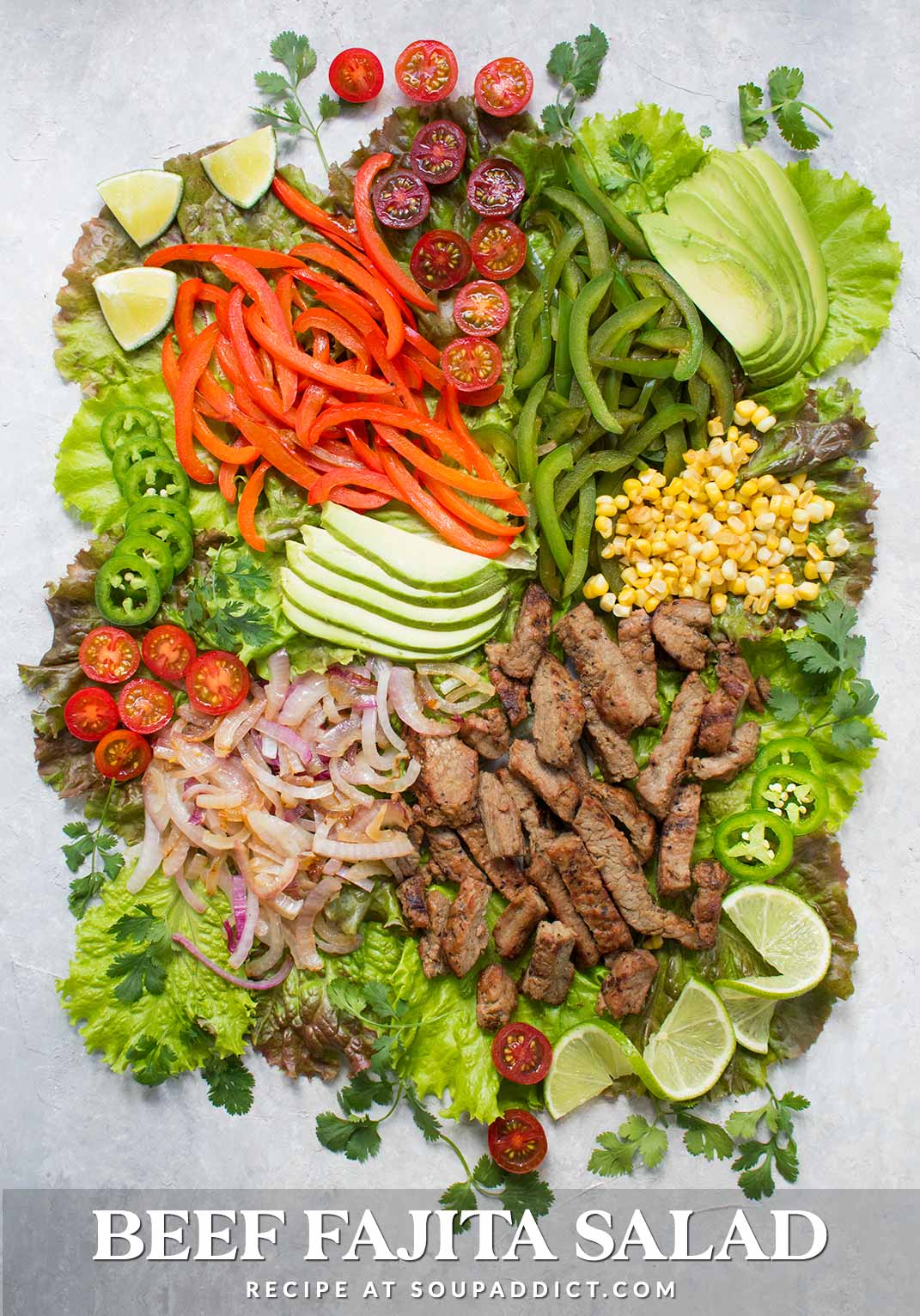Ingredients of beef fajita salad spread out on board