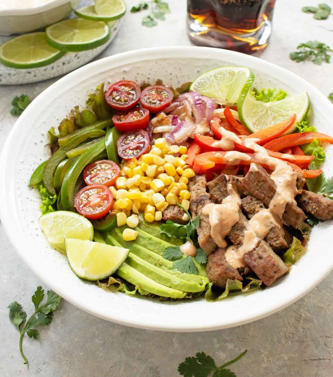 Side angled view of a bowl of Steak Fajita Salad.