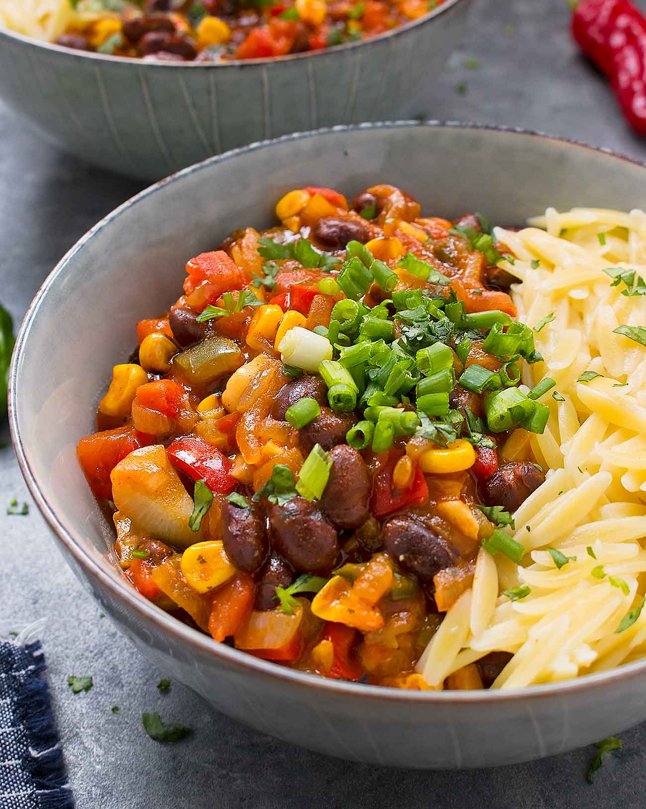 Close up of Mexican chili with orzo in bowl.