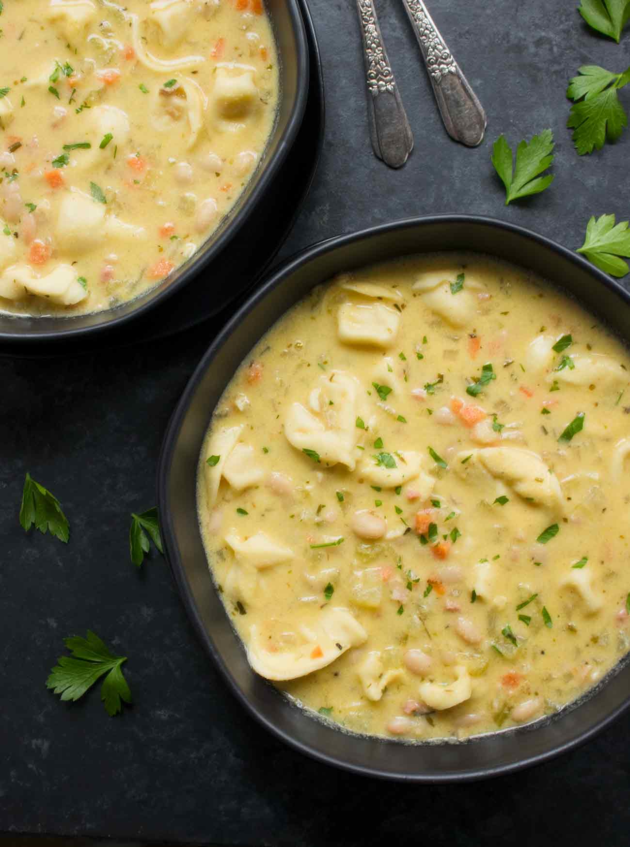 Two bowls of creamy white bean tortellini soup