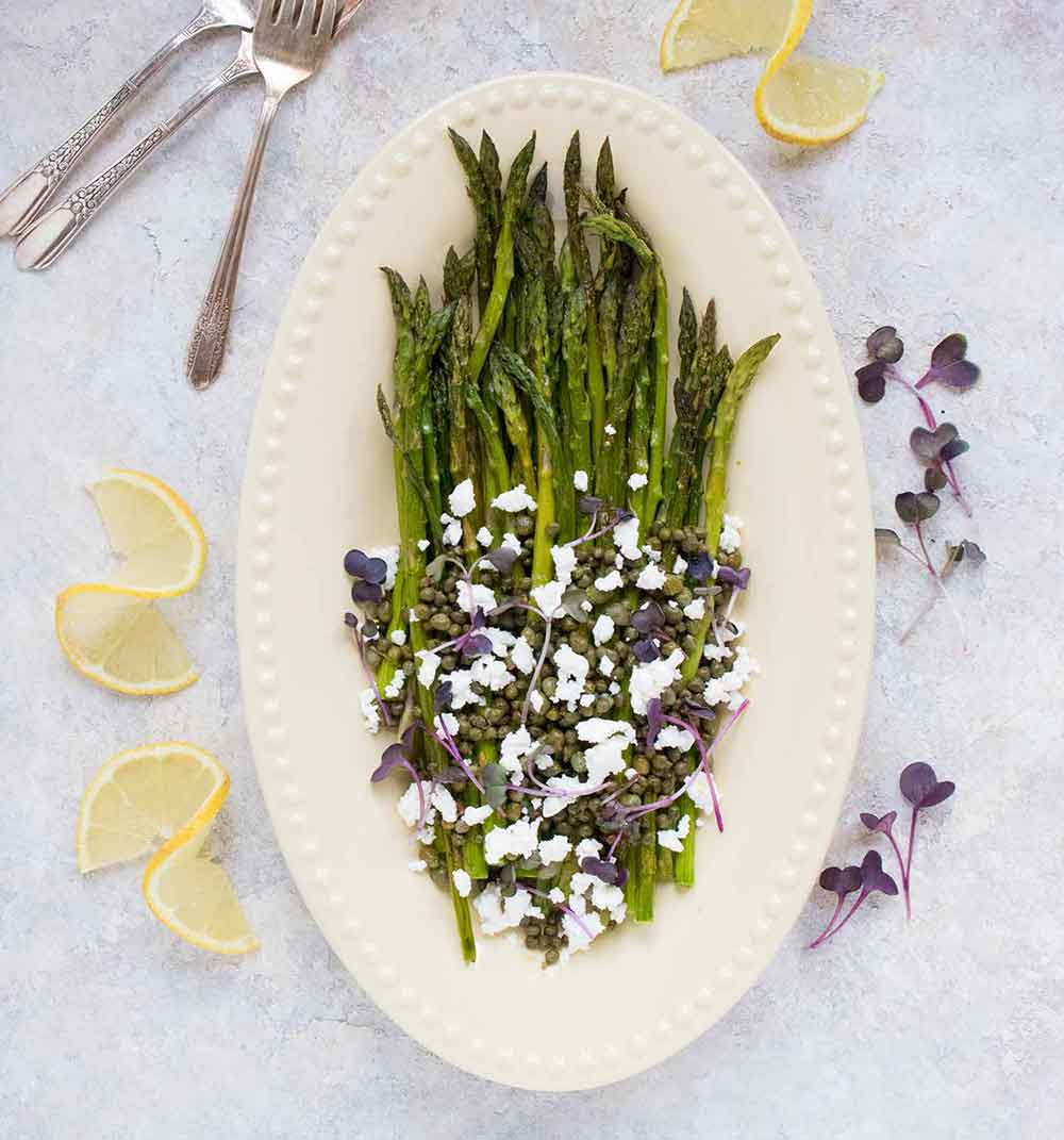 Roasted asparagus with feta, on a serving platter.
