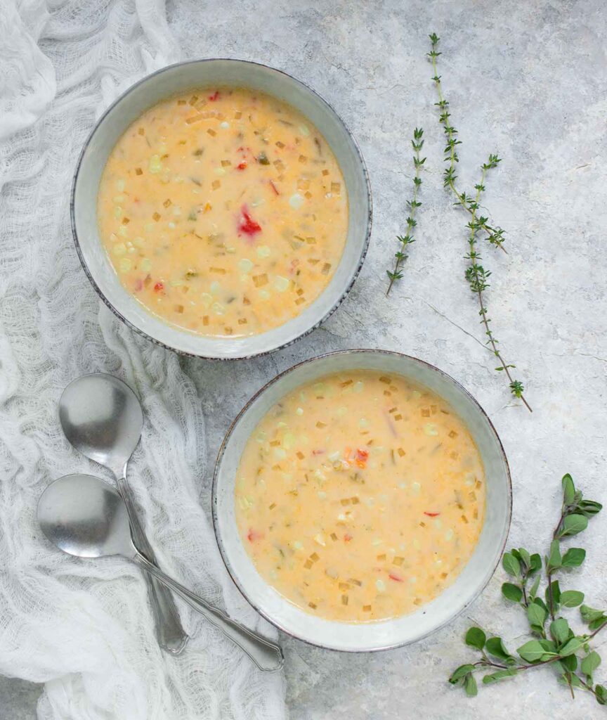 Two bowls of Smoky hatch chile corn chowder, ready to serve