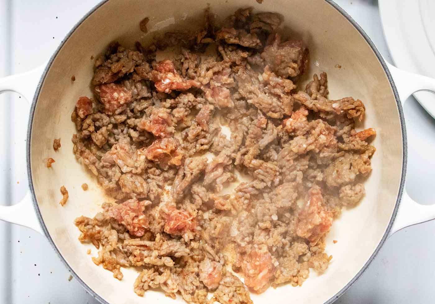 Italian sausage cooking in the soup pot.