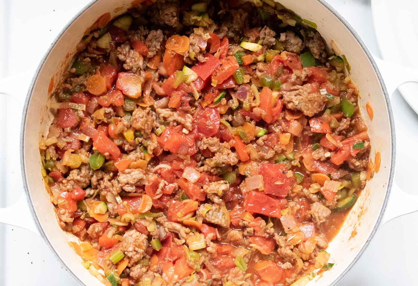 Seasonings and tomatoes go into the pot!
