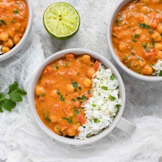 Three bowls of chickpea peanut stew with cauliflower rice blend