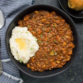 Vegan Irish Stew for lentil lovers in a bowl, topped with mashed potatoes