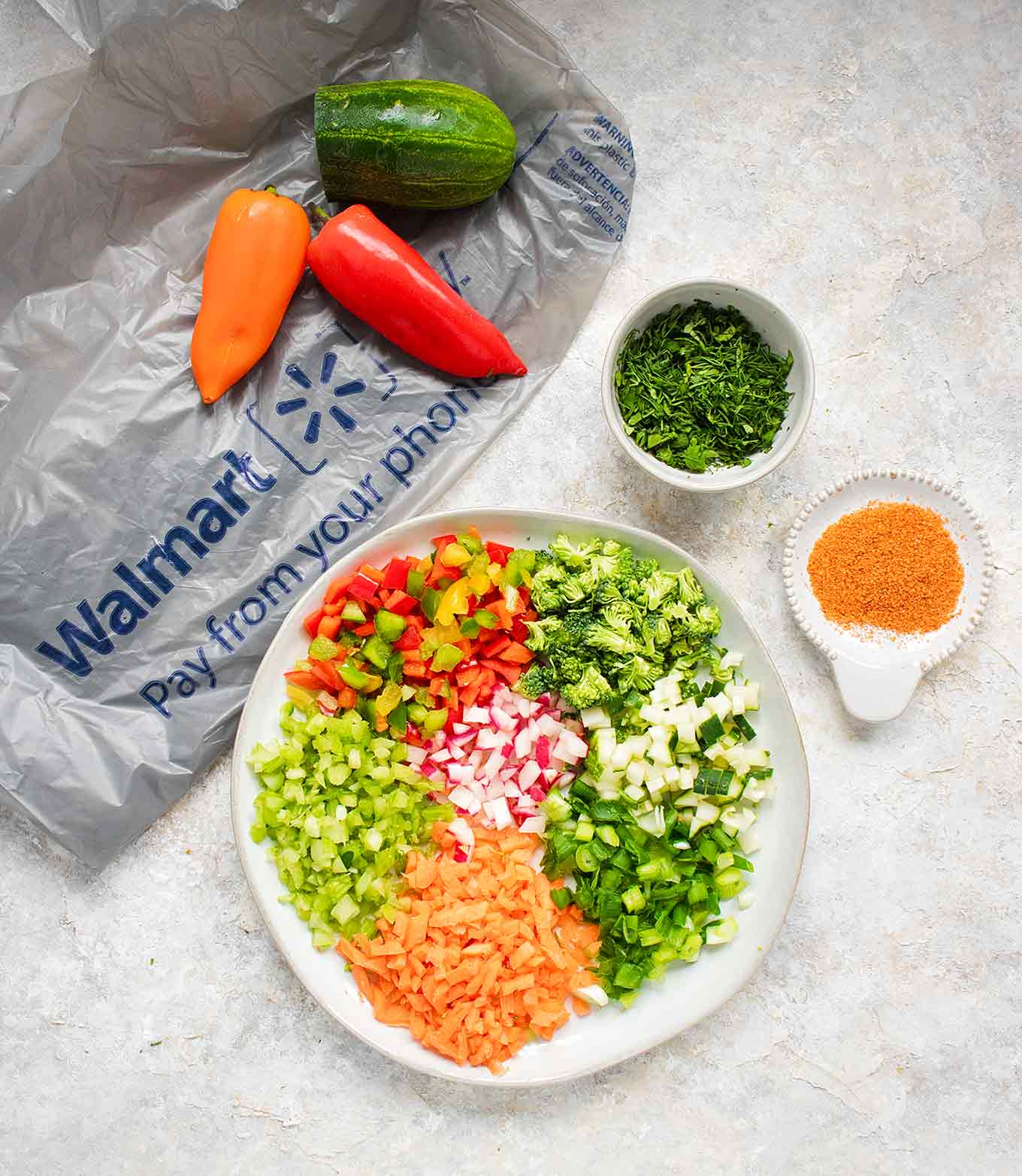 A rainbow of chopped veggies on a plate, ready to top the Ranch Veggie Pizza Appetizer