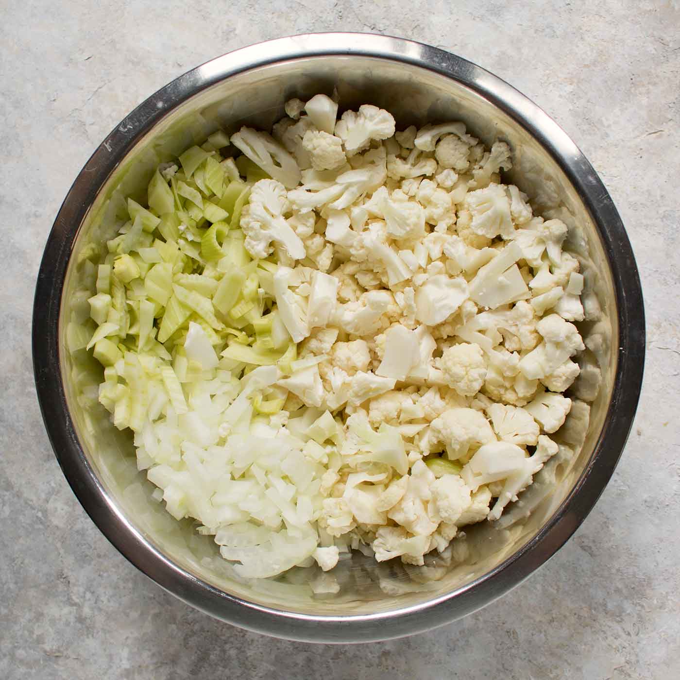 Ingredients for cauliflower fennel soup in a mixing bowl.